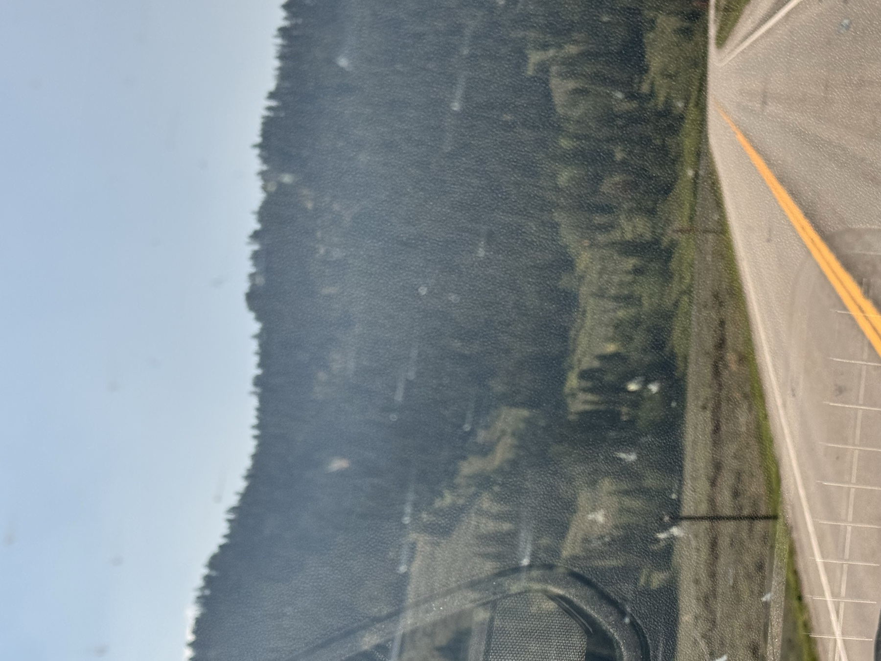 Smoke-softened forested peaks beside the road toward Jackson